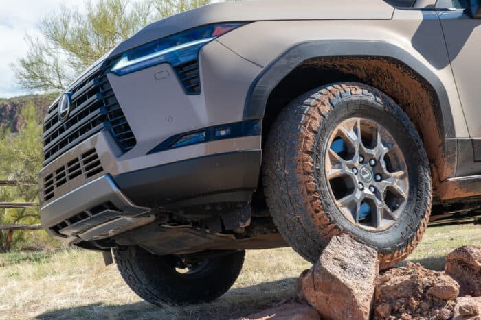 2024 Lexus GX 550 Overtrail wheel up close on top of pile of big rocks