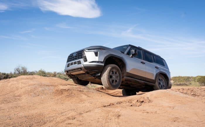 2024 Lexus GX 550 Overtrail offroading with front wheel off the dirt