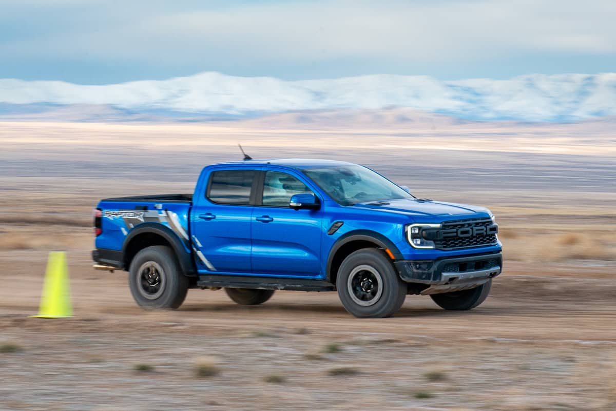 Front view driving shot of a blue 2024 Ford Ranger Raptor at the Ranger Raptor Assault School in Tooele Valley, Utah