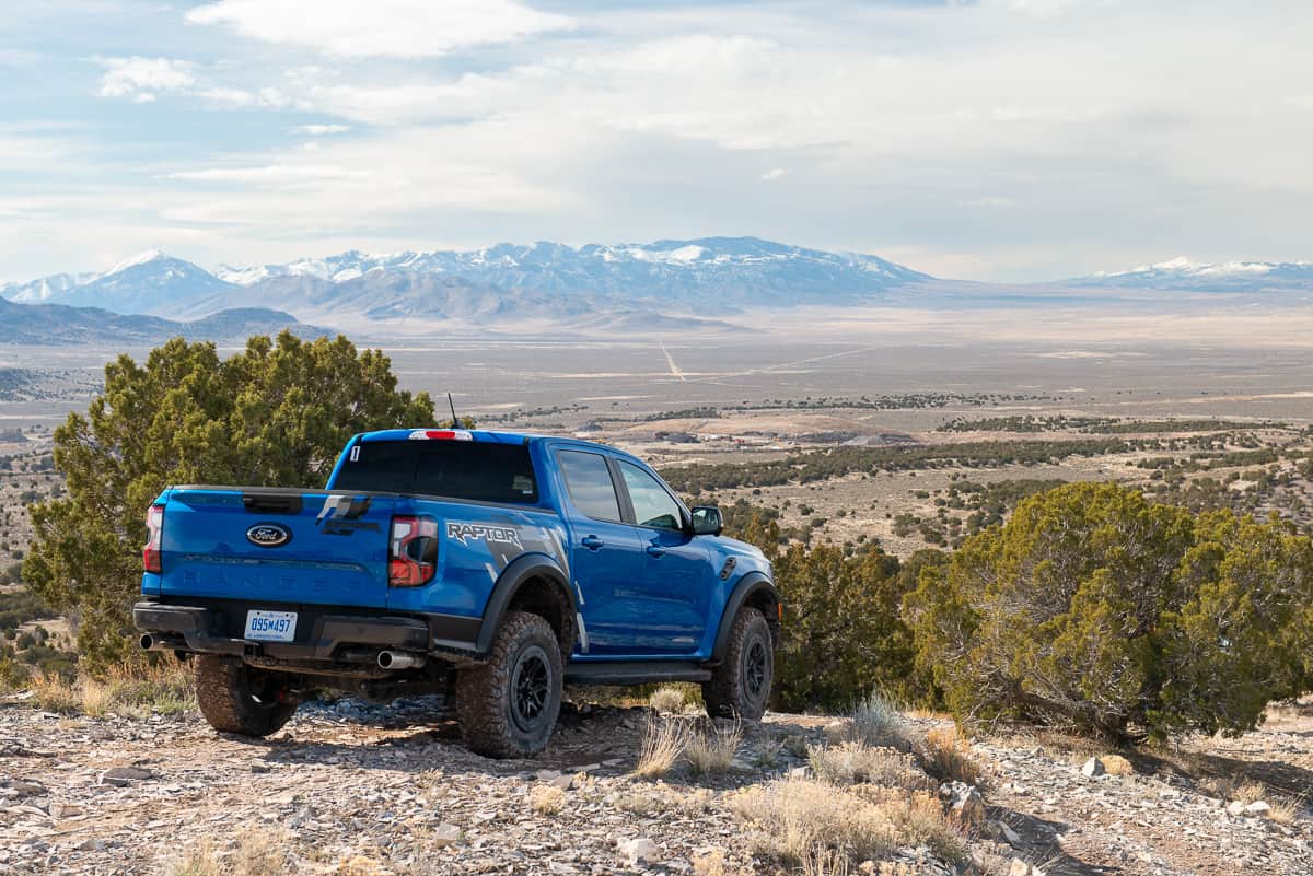 Rear shot of a blue 2024 Ford Ranger Raptor at the Ranger Raptor Assault School in Tooele Valley, Utah, overlooking the valley below