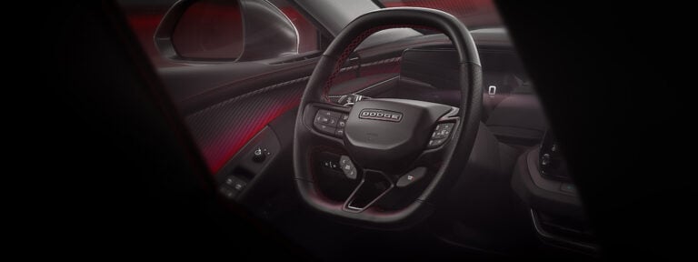 The steering wheel of the Dodge Charger is performance oriented and technical in feel, with a heated flat top/flat bottom design, and includes paddle shifters to manage regenerative braking and a PowerShot button — located on the front of the wheel for quick access — for the Charger Daytona Scat Pack and R/T.