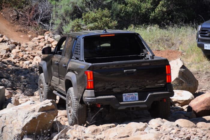 2024 Toyota Tacoma Hybrid i-Force-Max rear off roading on rocks
