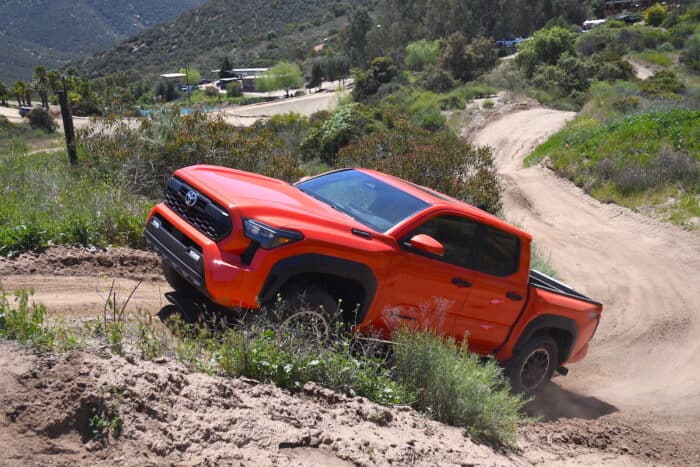 2024 Toyota Tacoma Hybrid i-Force-Max TRD Pro driving up dirt hill