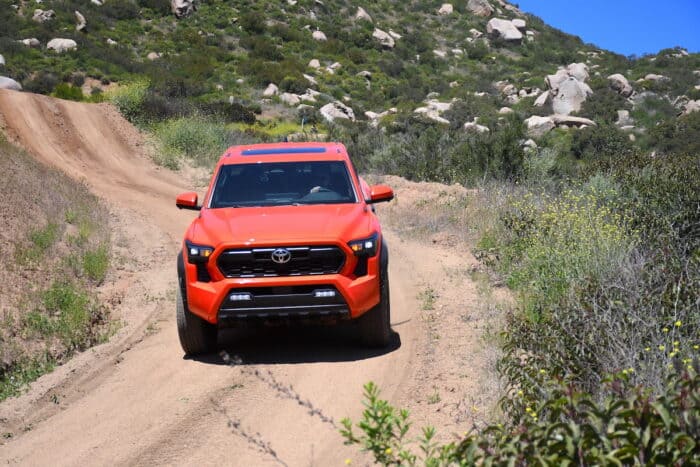 2024 Toyota Tacoma Hybrid i-Force-Max TRD Pro front view coming down a hill