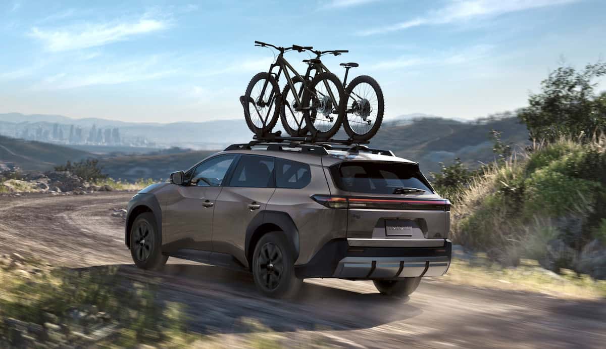 2026 Toyota bZ Woodland rear driving with bike rack on roof