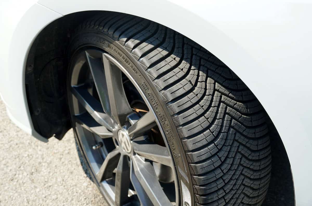 The tire on a white car is shown.