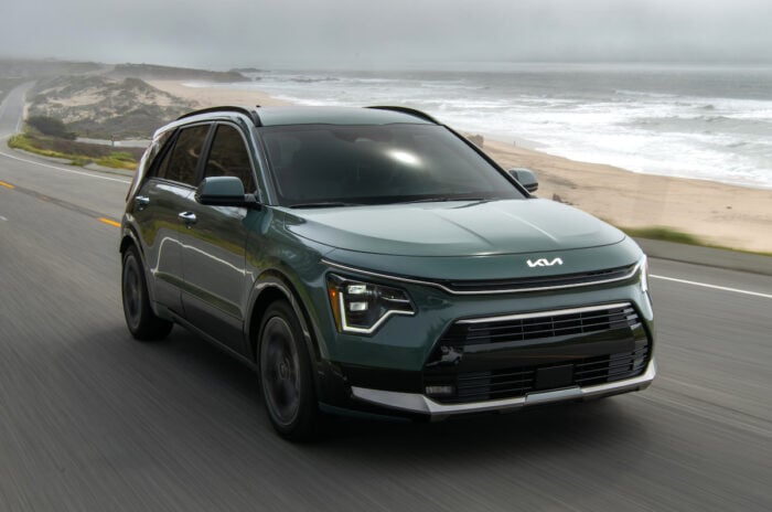 2026 Niro front view driving on road near the ocean