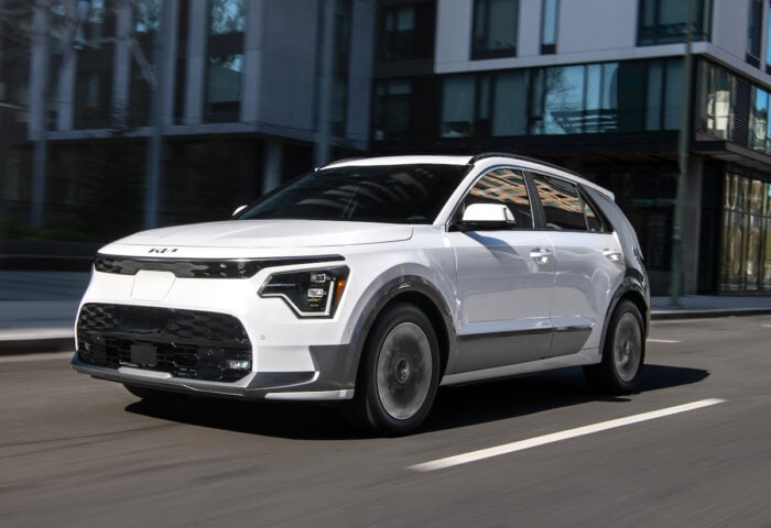 White 2026 Niro EV front view driving on road