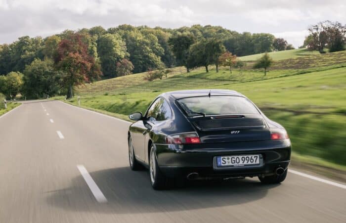 Black Porsche 996 rear on the road