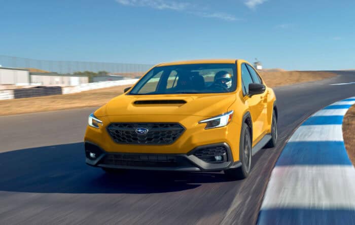 2026 Subaru WRX yellow driving on track front view