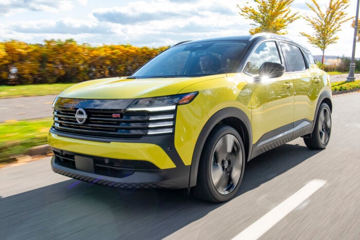 yellow new Nissan Kicks front view driving on the road