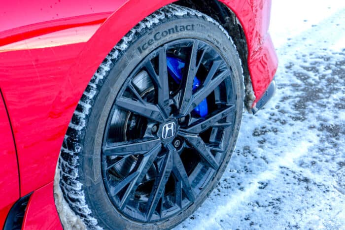 red 2026 Honda Prelude wheel with blue caliper up close in the snow