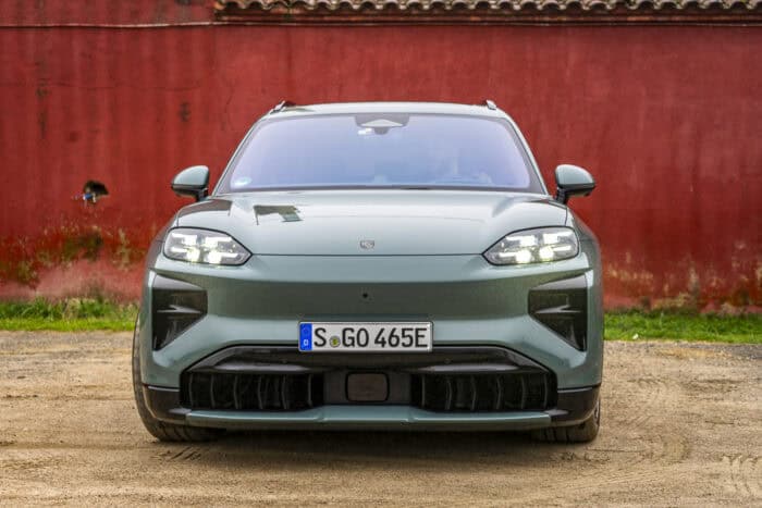 2026 Porsche Cayenne Turbo Electric front parked by red barn