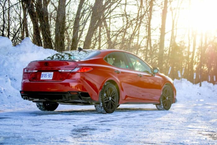 Red 2026 Toyota Camry SE Nightshade rear shot in the snow at sunset