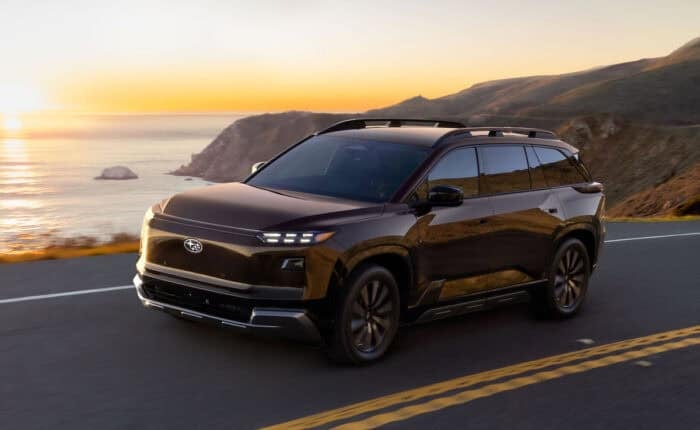 2027-Subaru-Getaway front view driving on the road by ocean at sunset