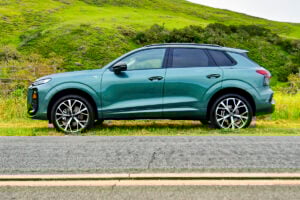 Green 2026 Audi Q3 side view parked on road