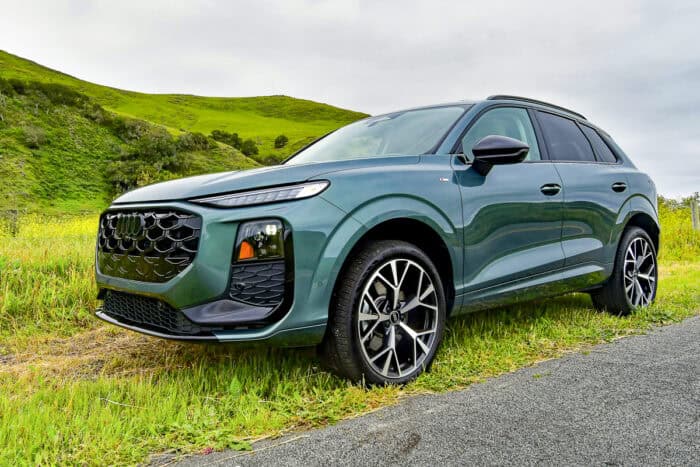 Green 2026 Audi Q3 front view parked on the grass by the road