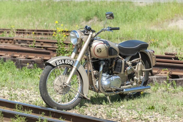 1952 BSA Golden Flash front view parked on grass near old train tracks