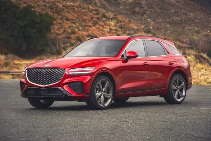 Red 2025 Genesis GV70 front view parked on road