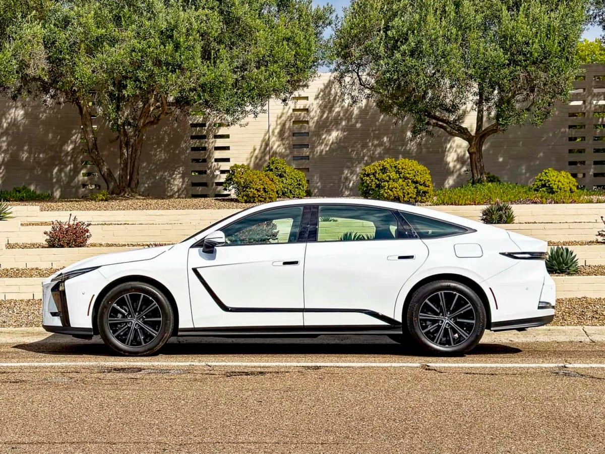 White 2026 Lexus ES 350h AWD side view parked on road