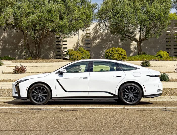 White 2026 Lexus ES 350h AWD side view parked on road