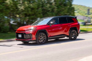 Red 2026 Toyota RAV4 GR Sport front view driving fast on road
