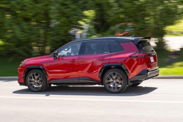 Red 2026 Toyota RAV4 GR Sport rear view driving by fast