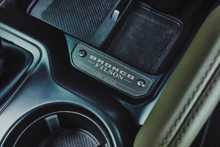 Close-up of Bronco F-150 badge on vehicle interior dashboard.
