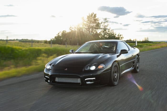 1999 Mitsubishi 3000GT VR4 front rolling on the road against the sunset