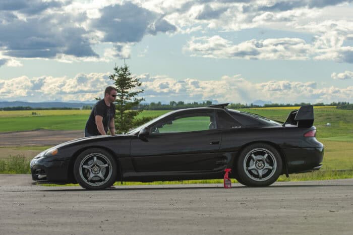 1999 Mitsubishi 3000GT VR4 side view parked on road with the owner