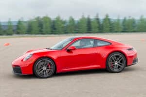 Red 2026 Porsche 911 Carrera GTS driving by
