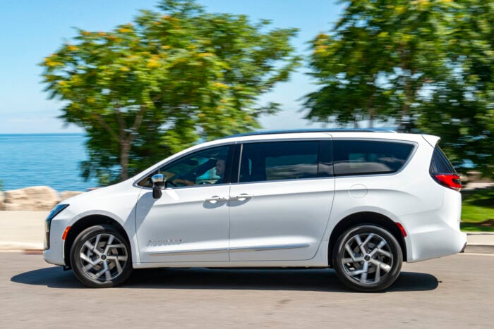 White 2027 Chrysler Pacifica Pinnacle side view driving by