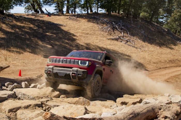 2026 Jeep Recon EV front view climbing up rocks